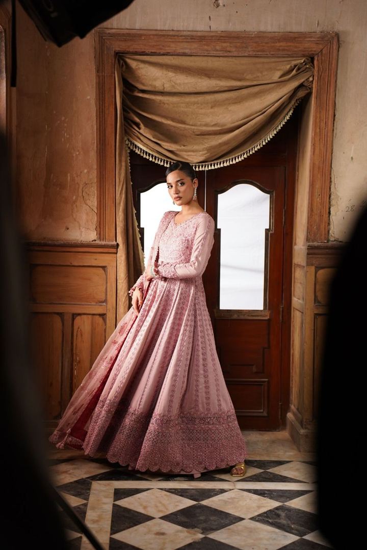 Woman in a blush flared anarkali gown