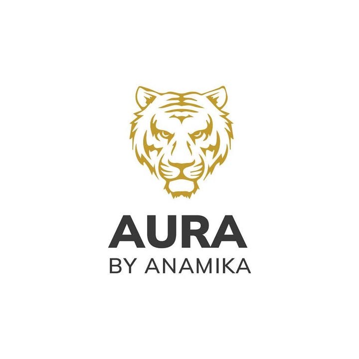 AURA by Anamika logo: a gold tiger above the wordmark