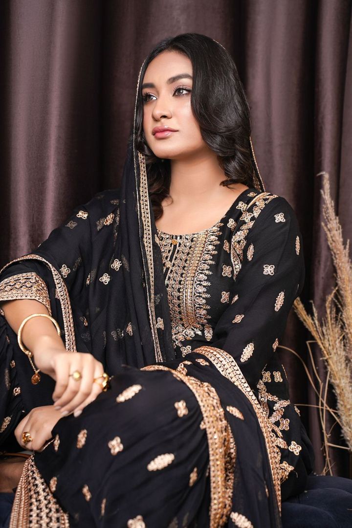 Woman in a black zari suit with dupatta